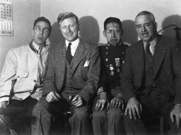 Harold Gauer, Carl Zeidler, Robert Bloch, and unidentified man (possibly Max Pollack). Both Gauer and Bloch are posing humorously in costumes.