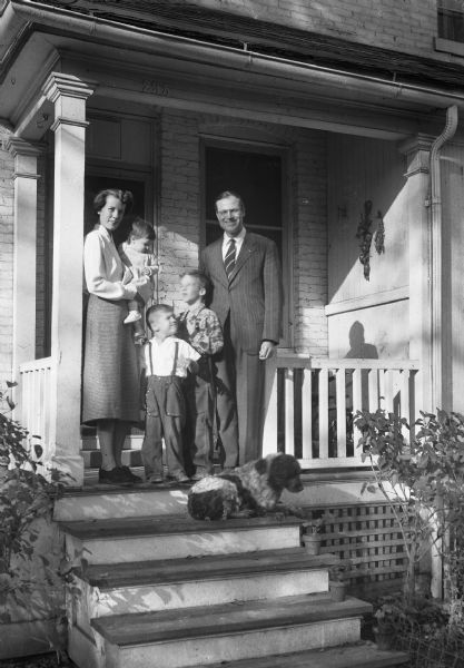 A campaign picture of Democrat Henry and Marge Reuss with family and pet dog on front porch. Taken for Ruess' Run for Mayor after his service in Europe.