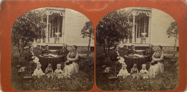 "Professor R.B. Anderson, his Family & Visitors." Seated outdoors left to right around a table are: Mrs. R.B. Anderson, H. Herlofson, Professor Rasmus B. Anderson and Mrs. Ole Bull (Sara J. Thorp). The children include Olea Bull, Carlotta Anderson and George K. Anderson. Professor Anderson was a professor of Norwegian at the University of Wisconsin and founder of the Scandinavian Studies department. He introduced his friend, famed Norwegian violinist, Ole Bull, to the much younger Sara Thorp. They were wed in 1870.