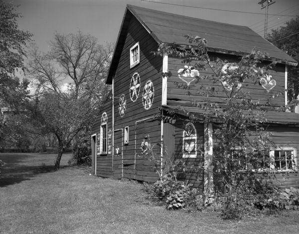 View of a barn decorated with painted Pennsylvania-German hex signs.