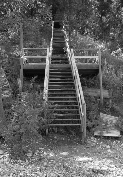 View from shore up an outdoor, wooden stairway from the Red Banks Supper Club to the lake shore. The stairs were once used as a means to reach a swimming beach on the lake.