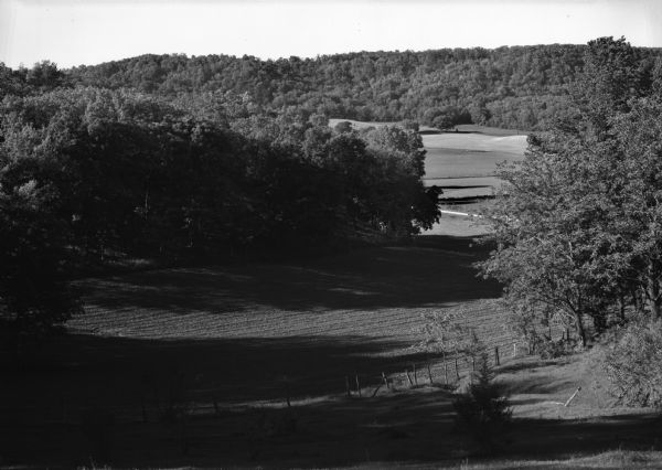 Landscape view of a shaded field hollow on George Melanthin's farm.