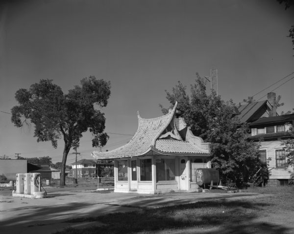 Exterior view of an abandoned "Bonus" gasoline station. This station was formerly a Wadham's Oil and Grease Company station. The Wadham's chain, headquartered in Milwaukee, Wisconsin, featured distinctive, pagoda-style architecture.