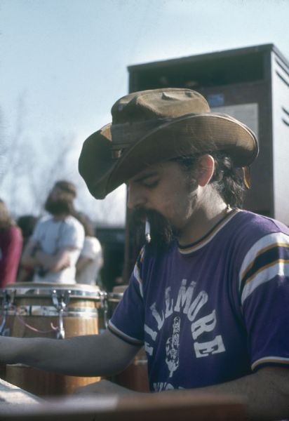 Ron "Pigpen" McKernan playing keyboards on stage with the Grateful Dead. His t-shirt reads "Fillmore West."