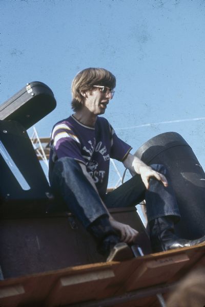 Grateful Dead bassist, Phil Lesh, wearing a Fillmore West t-shirt, sits on stage surrounded by equipment before performing at the Sound Storm music festival.