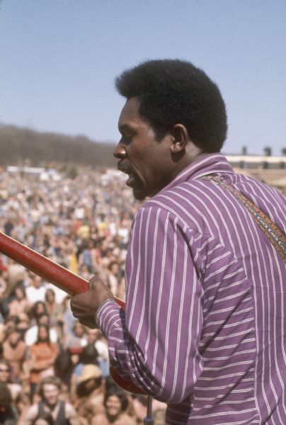 Close-up of Guitarist Luther Allison on stage at the Sound Storm festival playing a Gibson Guitar in front of an audience.