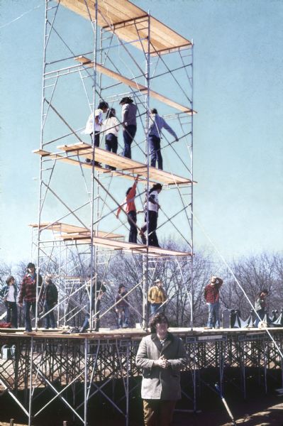 Workers amid construction of the stage and the scaffolding that will hold speakers.