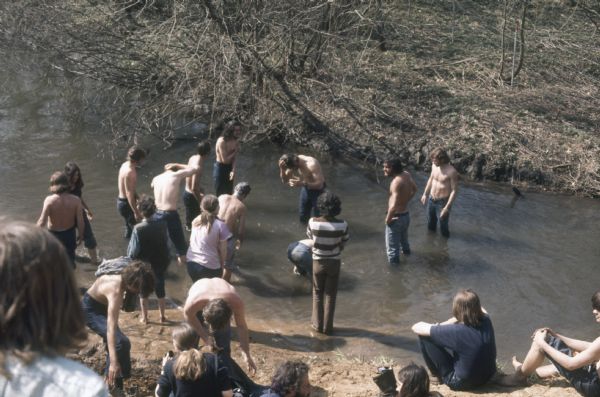 A group of young men and women bathe in Rowan Creek near York Farm during the Sound Storm music festival.