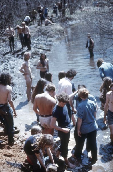 Elevated view of a large group of people bathing in Rowan creek near York Farm during the Sound Storm music festival.