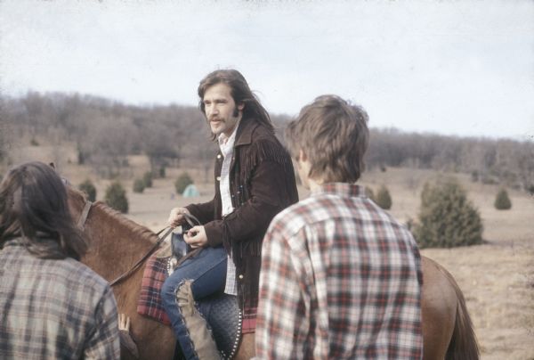 Peter Obranovich (better known at the time as "Pete Bobo"), promoter for the festival, on horseback talking to festival staff at the Sound Storm music festival.