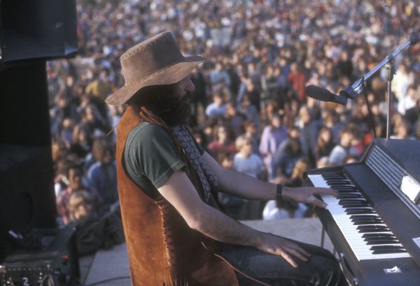 Rick Durett, keyboard player for the country rock band Mason Proffit, performing at the Sound Storm music festival. The crowd in front of the stage can be seen behind him.
