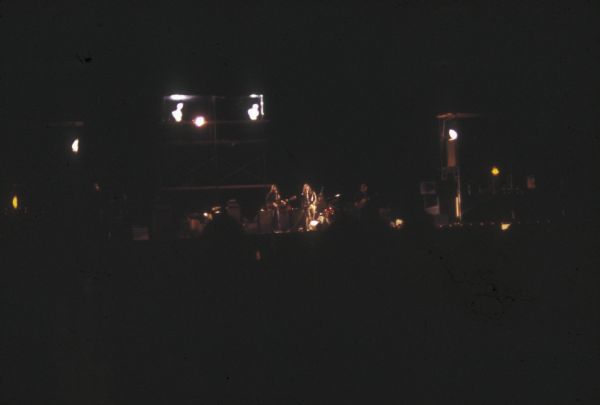 View from audience of an unidentified band performing on stage at night at the Sound Storm music festival.