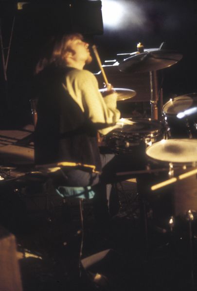 An unidentified drummer performing with an unidentified band on stage at night at the Sound Storm music festival as seen from the rear of the stage.