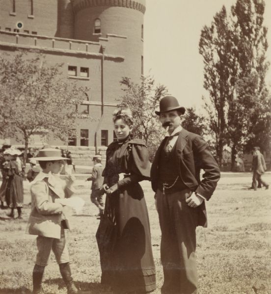 The members of the Phillips family stand on the lawn outside of the University of Wisconsin-Madison Armory (Red Gym or Old Red).