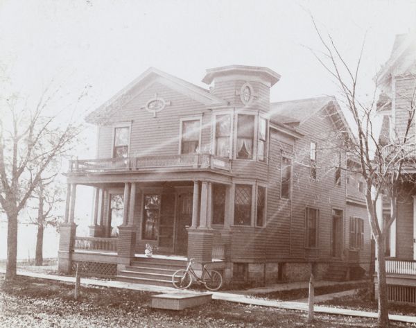 An exterior view of a home on S. Henry Street owned by C.A. Coon, an employee in the Department of "R.R. Conservation." The Victorian home has several decorative windows, a modified turret, and a modestly-decorated porch.