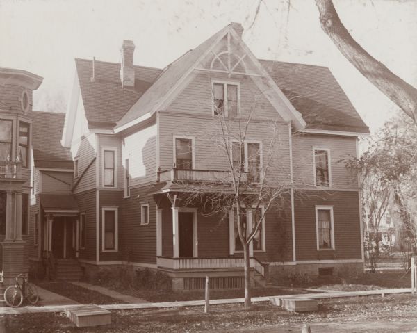 Exterior view of the Sarah B. Winn house on South Henry Street. The house is decoratively painted in two tones which are divided by a string course between the first and second floors.
