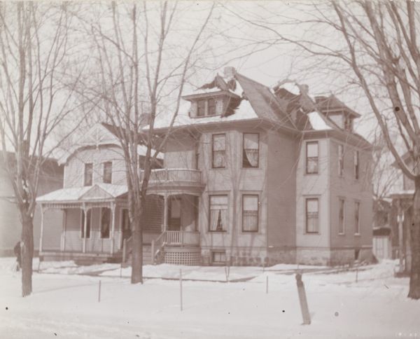 An exterior view of the Henry Schildhauer residence on West Washington Avenue. Mr. Schildhauer was the Chief Department of Revenue Collector for the State of Wisconsin. The two and one-half story house has a small decorative porch on both the first and second floors.