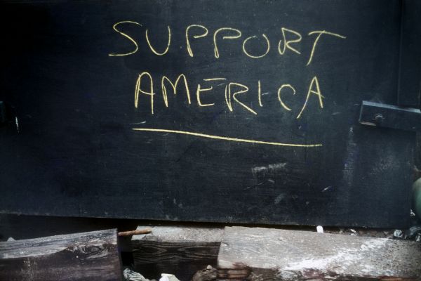 "Support America" sign posted in proximity to the construction of the World Trade Center towers.