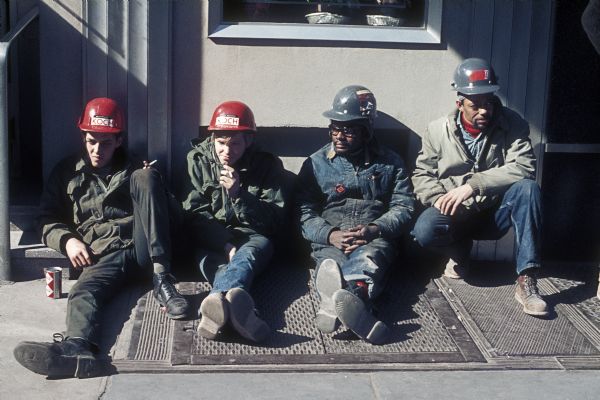 Construction workers with hard hats take a break while working on the construction of the World Trade Center.