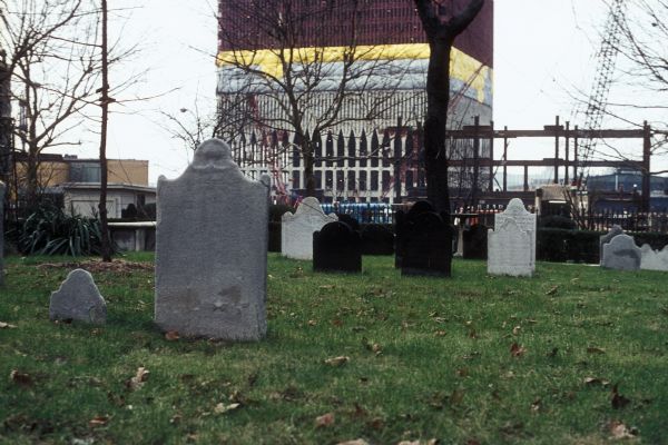 View of the construction of the World Trade Center from the churchyard at St. Paul's Chapel.