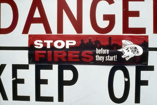 A "Danger Keep Off" sign is visible with an additional sticker that reads, "Stop Fires Before They Start."
