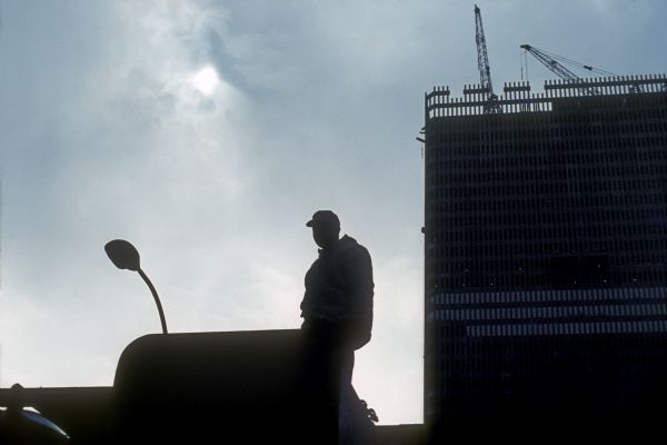 Silhouette of a construction worker and construction cranes at the World Trade Center.