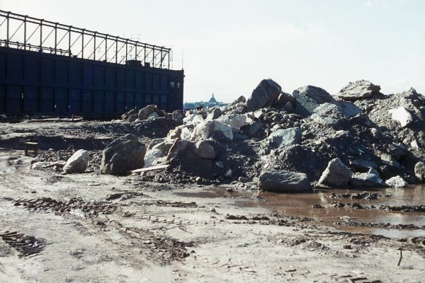 A large pile of rocks, mud and dirt is visible in a construction site.
