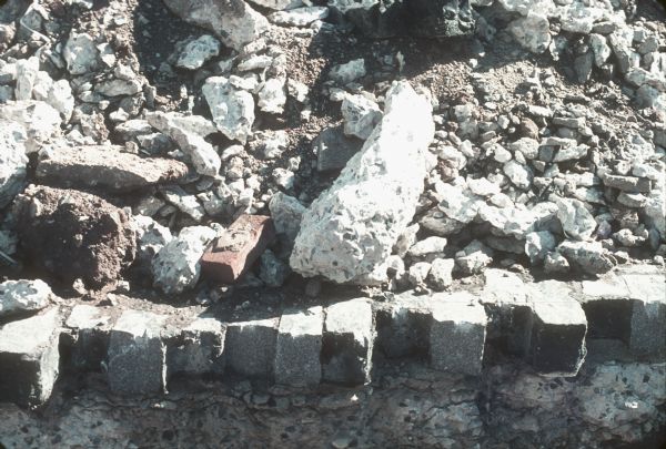 Piles of rock and brick are visible in the construction site.