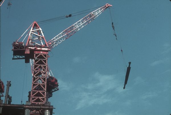 View of a large crane that carrying building materials at the construction site of The World Trade Center.