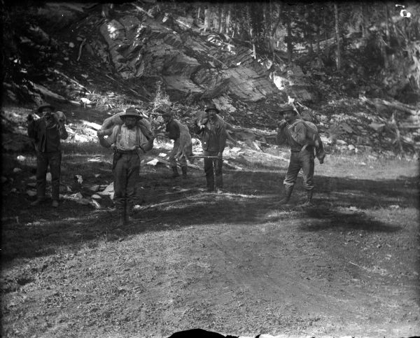 Men carrying dead lambs back to the Leighton-Wyoming mining camp.