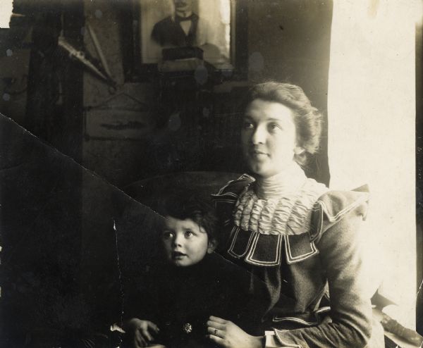 Aunt Helen sitting indoors next to a window with Syl on her lap.