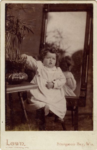 Infant Syl Dankoler posed in front of a mirror for a professional portrait.