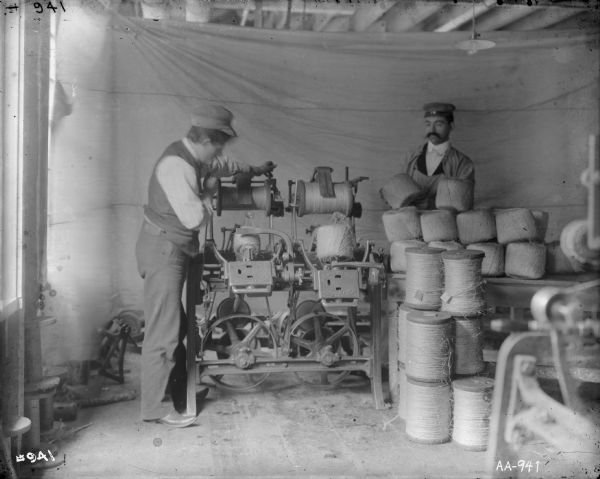 Factory workers use a balling machine at the McCormick Twine Mill to wind twine onto wooden spools.