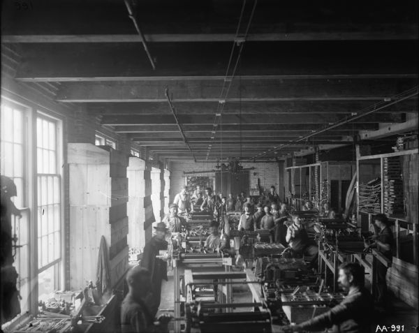 Elevated view of factory workers at stations in the Shredder Department at the McCormick Works.