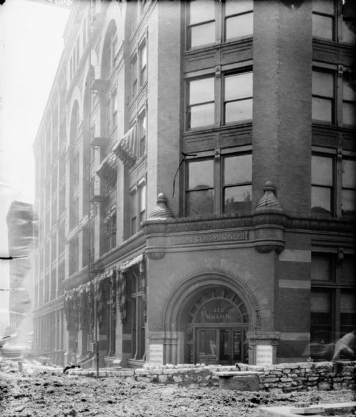 View of street being constructed outside the dealership office of the McCormick Harvesting Machine Co. on 212 Market Street.
