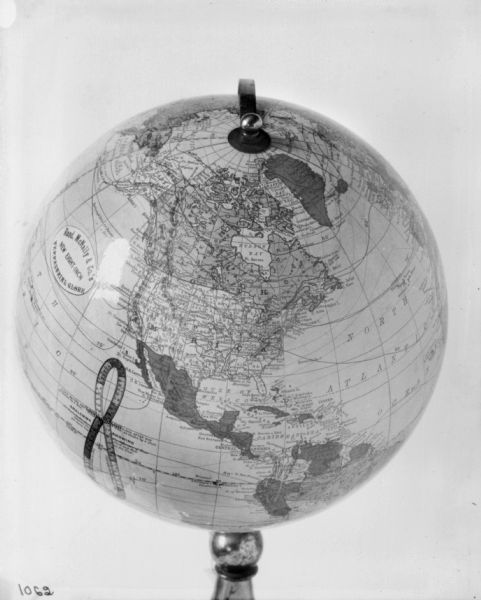 Rotating globe on stand with North America in the center.