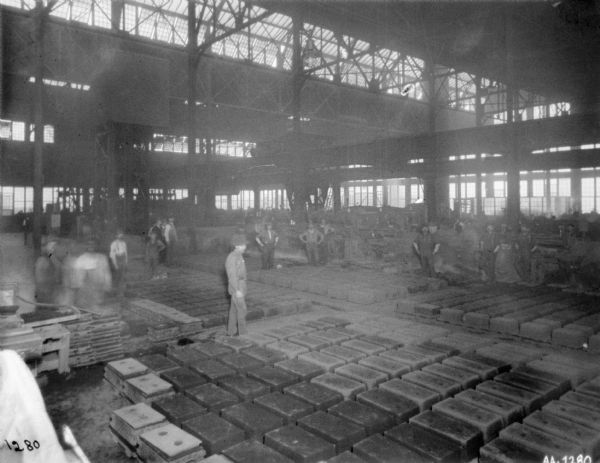 Slightly elevated view of men working in a foundry.
