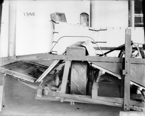 Early design of binder inside McCormick Works. There is a white sheet hanging in the background for a backdrop.