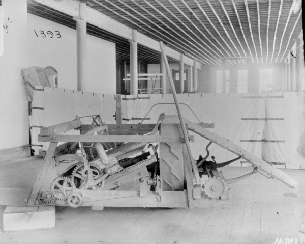 Early design of binder inside McCormick Works. There is a white sheet hanging in the background for a backdrop.