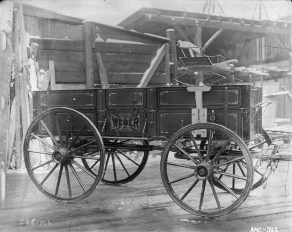 Weber Wagon parked outdoors. Buildings are in the background.