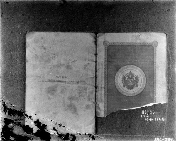 Front and back cover of a bound German document. The bottom half of the front cover is torn off.