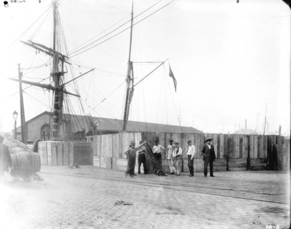 View towards men posing on shipping dock.
