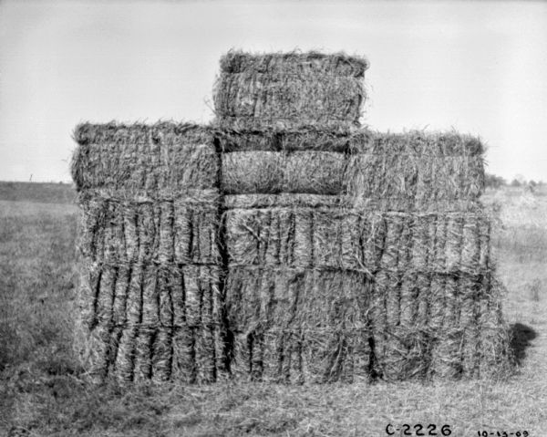 Stack of hay bales in a field.