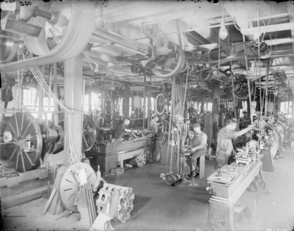 Men working in the metal finishing room in a factory.