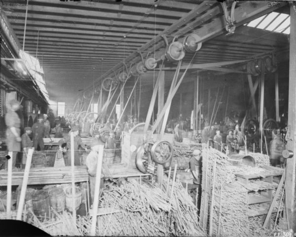 Interior view of men working in the bolt department at McCormick Works.