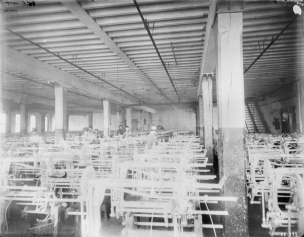 Interior view of men working in the paint shop at McCormick Works.