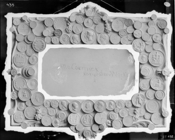 Coins around a mold or frame. In the center is written: "McCormick Harvester Works."