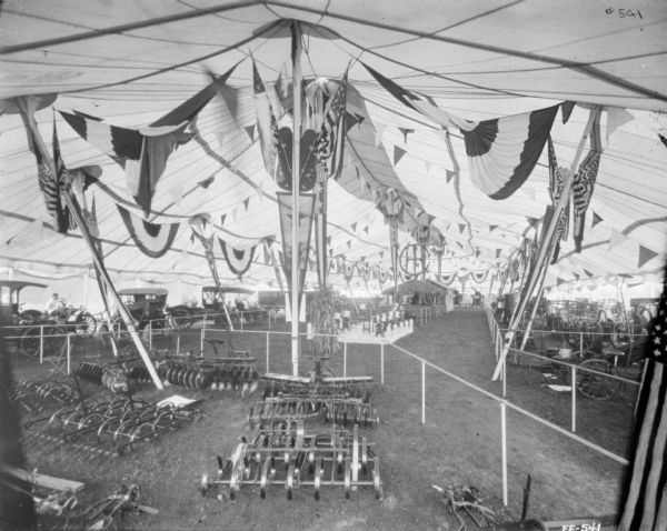 Elevated view of agricultural exhibit in a tent.
