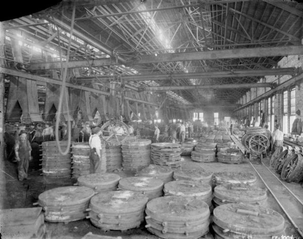 Men working in the foundry area of a factory.