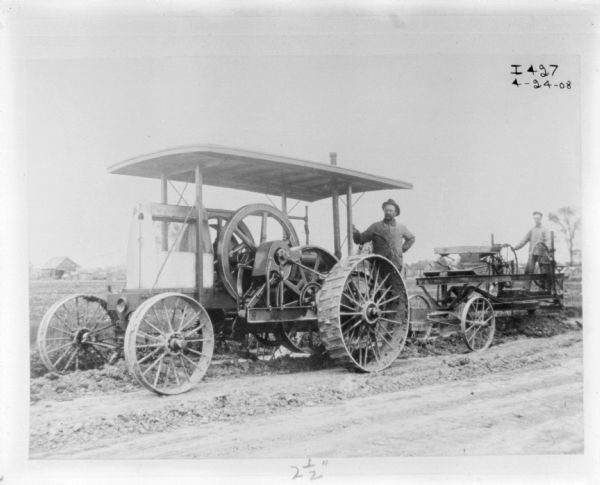 Men using a tractor for road construction.